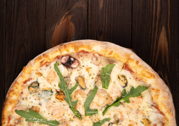istock Seafood Pizza with Mozzarella, Various Seafood and Arugula. 1443226291