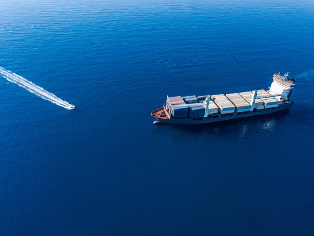 istock Aerial view on boat and container ship. Shipping cargo. Export, import and logistic 1443229290