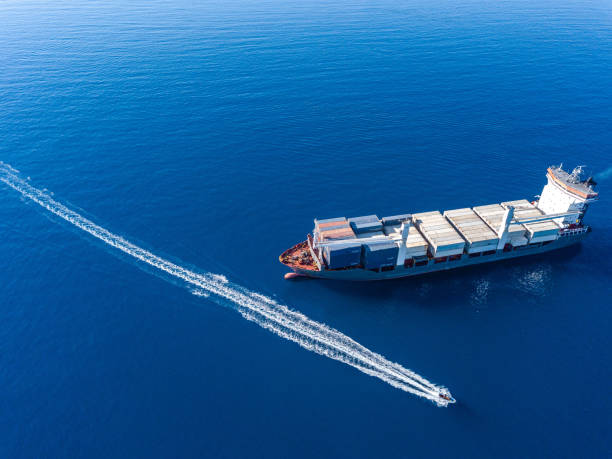 istock Aerial view on boat and container ship. Shipping cargo. Export, import and logistic 1443230173