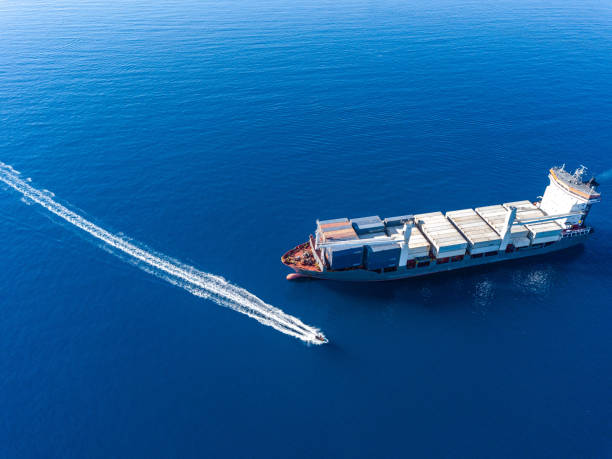 istock Aerial view on boat and container ship. Shipping cargo. Export, import and logistic 1443230796