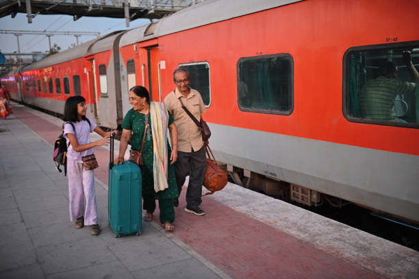 Panipat, Haryana, November 24th, 2012: A farmer family enjoying morning sun light while waiting for the train in a platform at Panipat Railway Junction of Haryana state of India.