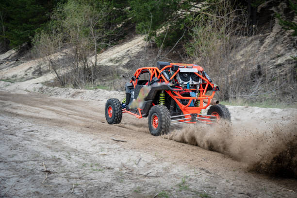 Professional quad biker rides fast on sand. Quad racing, ATV 4x4