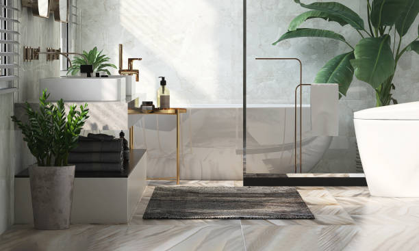 istock Modern and luxury design bathroom with bathtub, granite vanity, washbasin, side table and fiddle leaf fig tree in sunlight from window blinds on white marble wall and tile floor 1443232222