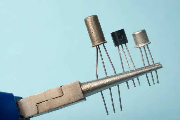 Photo of Precision pliers grips three different types of transistors