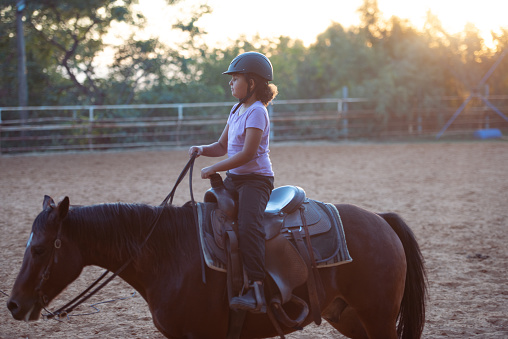 Girl enjoying horse ride.