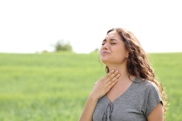 istock Stressed woman suffering throat ache in a field 1443236392