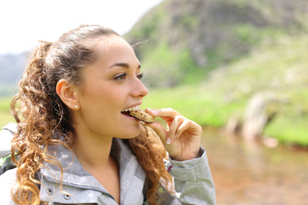 istock Hiker eating cereal bar in nature 1443236474