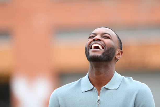 istock Happy black man laughing in the street 1443236559