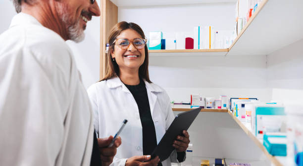 istock Two pharmacists working together in a chemist 1443236666