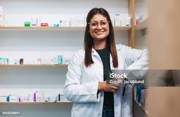 Female Pharmacist Standing In A Drug Store Stock Photo - Download Image Now - Pharmacist, Smiling, Pharmacy