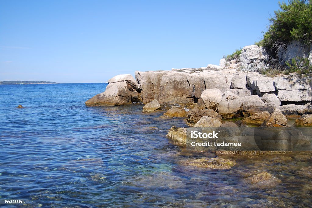 island Sainte-Marguerite a split on the island Sainte Marguerite, seen on bay of Cannes Bay of Water Stock Photo