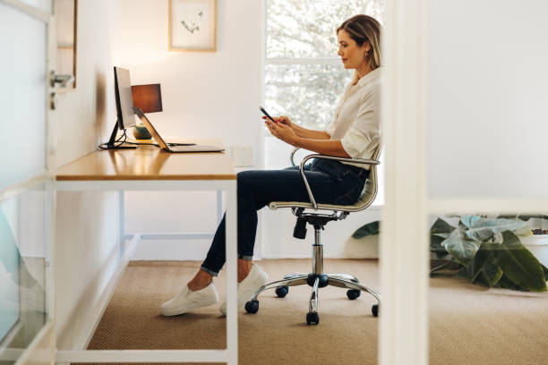 istock Business woman using a smart phone in her office 1443238222