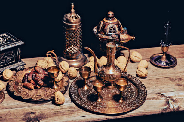 istock Persian Tea and teapots pouring hot tea in tea cups at a table. 1443238255