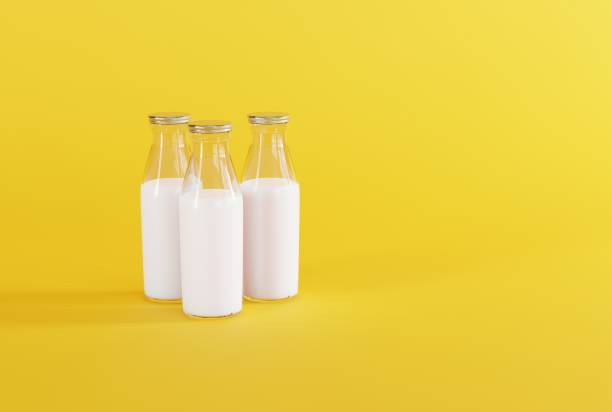 istock Retro bottles with milk on a yellow background. 1443239433