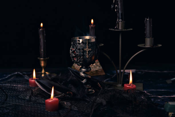 istock Witchcraft composition with candles, magic book and pentagram symbol. Altar for satanic rituals. Black magic and occult objects. 1443239544