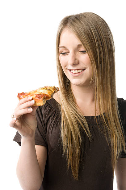 Woman eating pizza stock photo