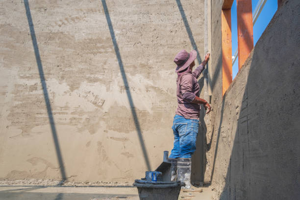istock builder worker using long trowel to polishing cement wall inside of house construction site 1443240051