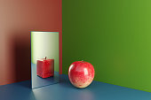 An apple in a mirror reflecting cube shaped version of himself