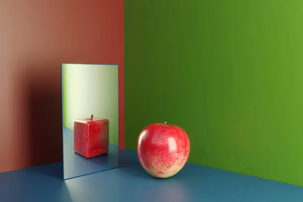 Photo of An apple in a mirror reflecting cube shaped version of himself