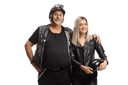 Elderly biker with a youn woman posing in leather clothes isolated on white background