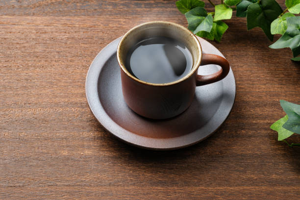 istock Hot black coffee isolated on wooden table 1443240309