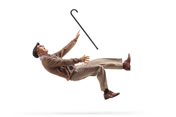 Elderly man with a walking cane falling stock photo