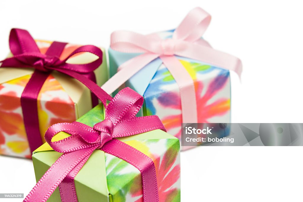 Gifts Three origami gift boxes on a white background. Focus on the pink ribbon of the box in front. Box - Container Stock Photo Gifts Three origami gift boxes on a white background. Focus on the pink ribbon of the box in front. Box - Container Stock Photo