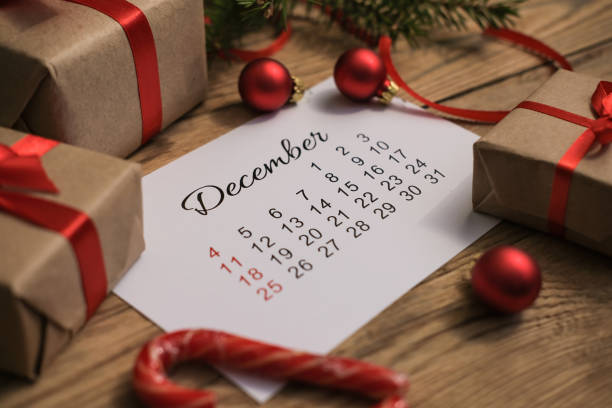 istock Gift boxes and December calendar on wooden table. Boxing day concept 1443243718