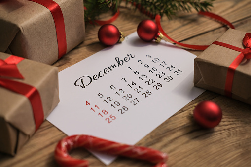 Gift boxes and December calendar on wooden table. Boxing day concept
