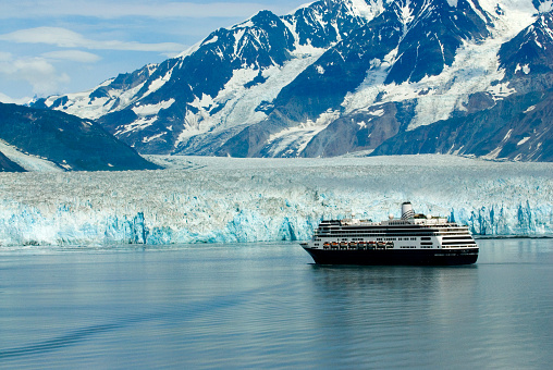 Alaska cruise shiip boat near glacier ice and mountain in pacific ocean