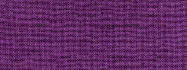 Texture of dark violet color background from textile material with wicker pattern. Vintage lavender fabric Texture of dark violet color background from textile material with wicker pattern, macro. Structure of vintage lavender fabric cloth, narrow backdrop. flax weaving stock pictures, royalty-free photos & images