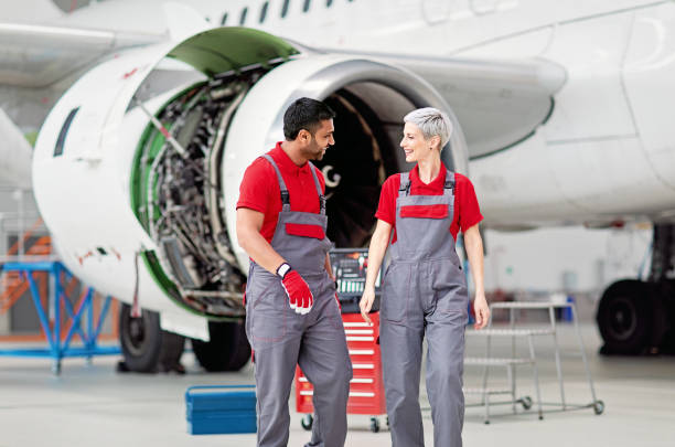 istock Airplane mechanics discussing planned aircraft maintenance in a hangar 1443246500