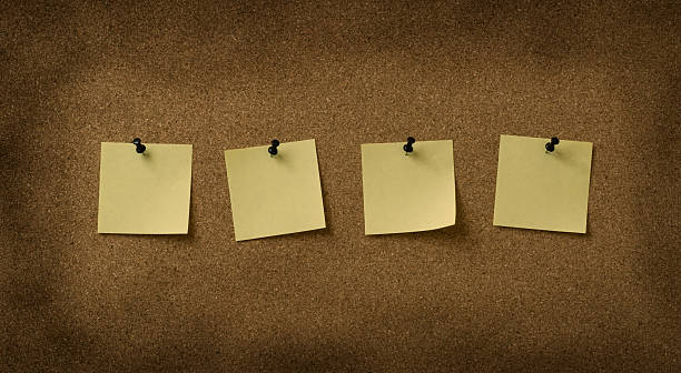 istock four yellow notes pinned to grunge cork background 144324688