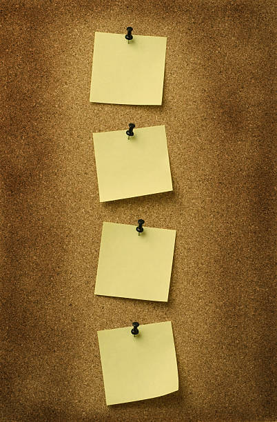 istock four yellow notes pinned to grunge cork background 144324691