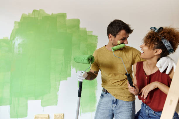 istock Happy couple talking while painting their new apartment. 1443247023