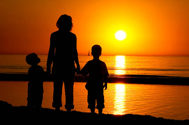 istock Family Standing At The Beach 144325086