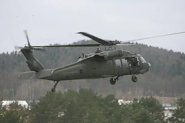 A UH-60L Blackhawk helicopter coming in for a landing during a field exercise in Germany.