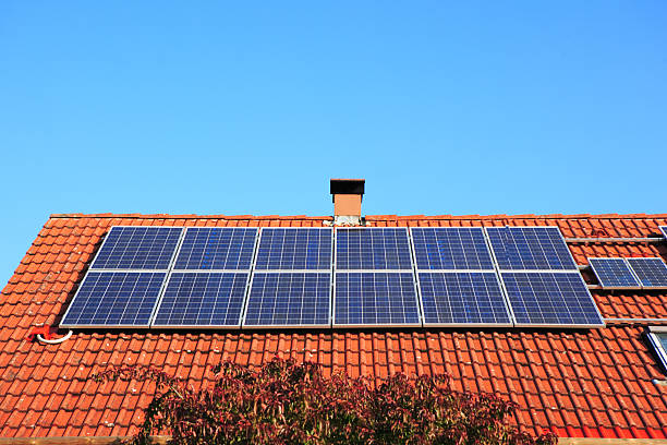 istock solar panels on red roof  and chimney 144325131
