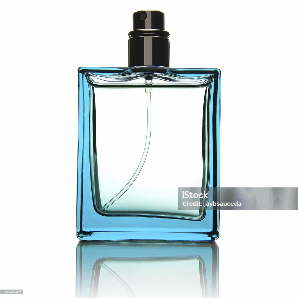 Fragrance Bottle A blank glass fragrance bottle with a clear liquid inside sitting on a glass surface. Perfume Sprayer Stock Photo