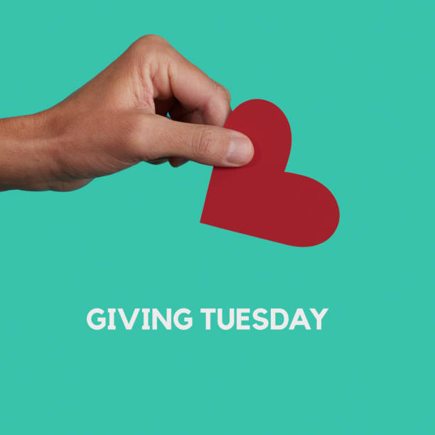 istock text giving tuesday and man giving a red heart 1443252466