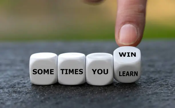 Dice form the expression 'sometimes you win' and 'sometimes you learn'.