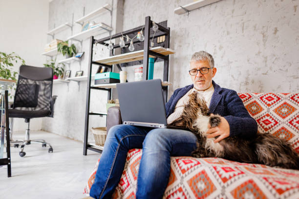 istock Man works on laptop while his dog wants to cuddle 1443257047