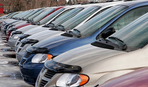 Cars in a row at a car dealership stock photo