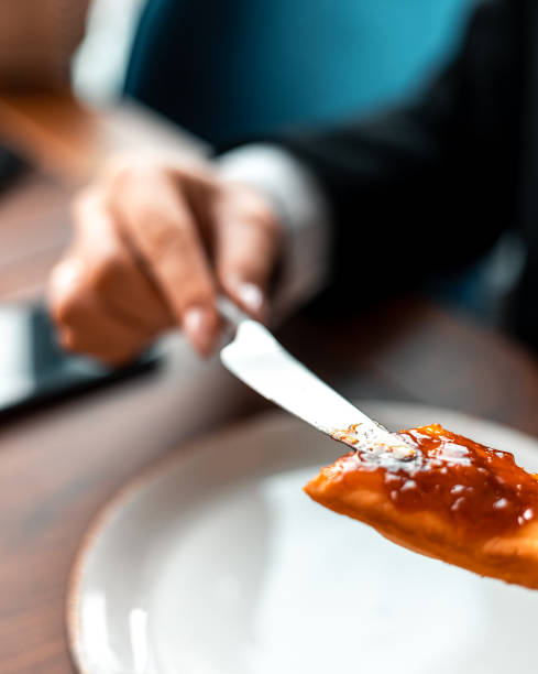 istock A woman's hand with knife spreads marmalade on fried bread 1443259417