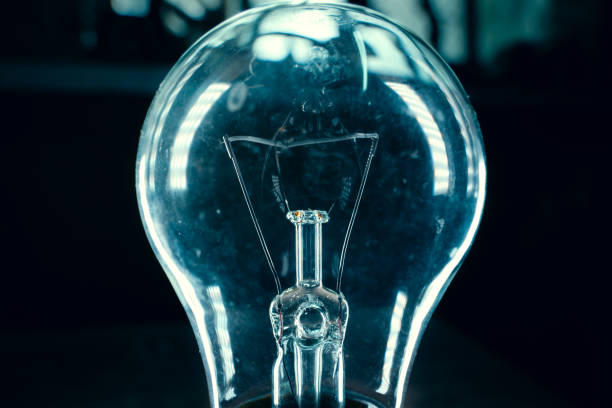 istock An old light bulb close-up in light highlights on a dark background with blue tones 1443260818