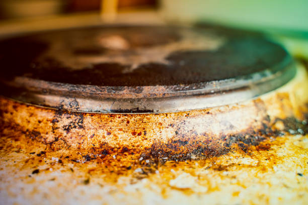 istock Very heavily soiled old kitchen electric stove in burnt brown soot and grease 1443260902