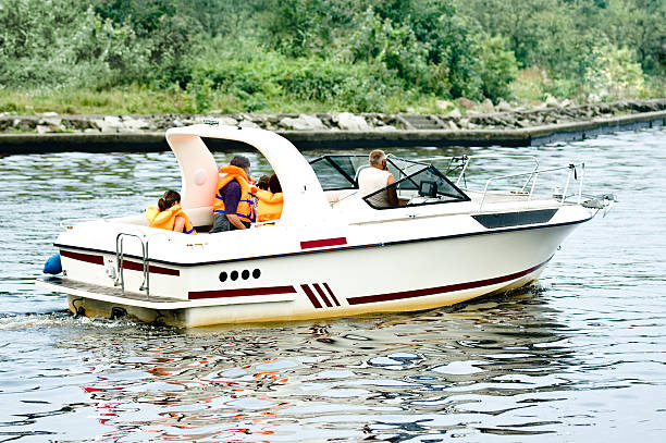 Motorboat journey A family floating by motorboat, kids on the board family motorboat stock pictures, royalty-free photos & images