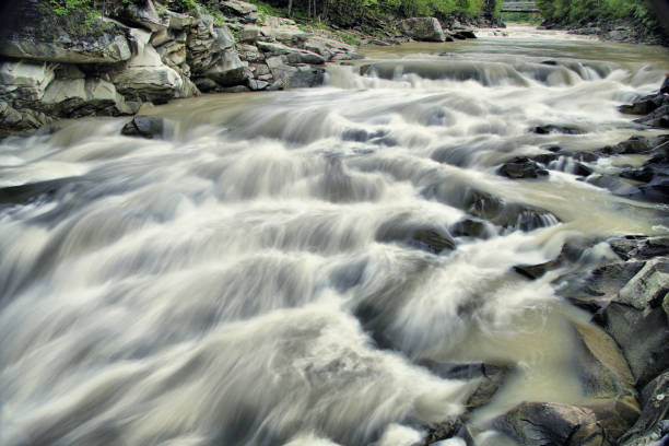 istock a mountain river slowly flows over the stones like a small waterfall. 1443261620