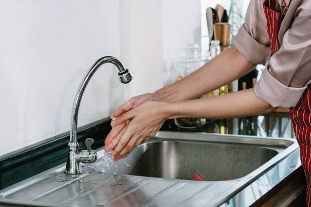 istock The cook is washing his hands in the sink. 1443262953