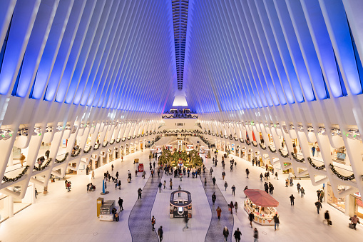 New York City, NY, USA - December 22, 2021: The Oculus interior at Westfield World Trade Center (designed by architect Santiago Calatrava and opened in 2016) with Christmas decorations in winter, Financial District